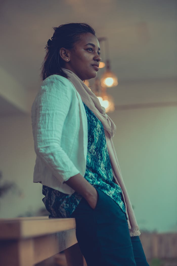 Side View of Woman in White Long Sleeves With Hand in Pocket